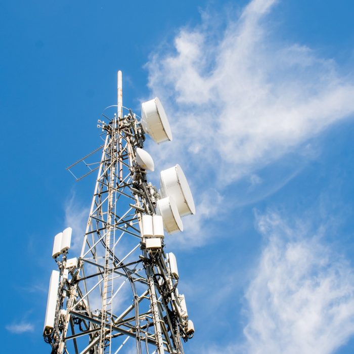 Radio, communication and cell tower on blue sky background